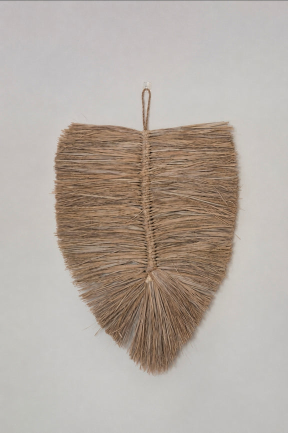Close-up van raffia wandhanger met natuurlijke structuur 