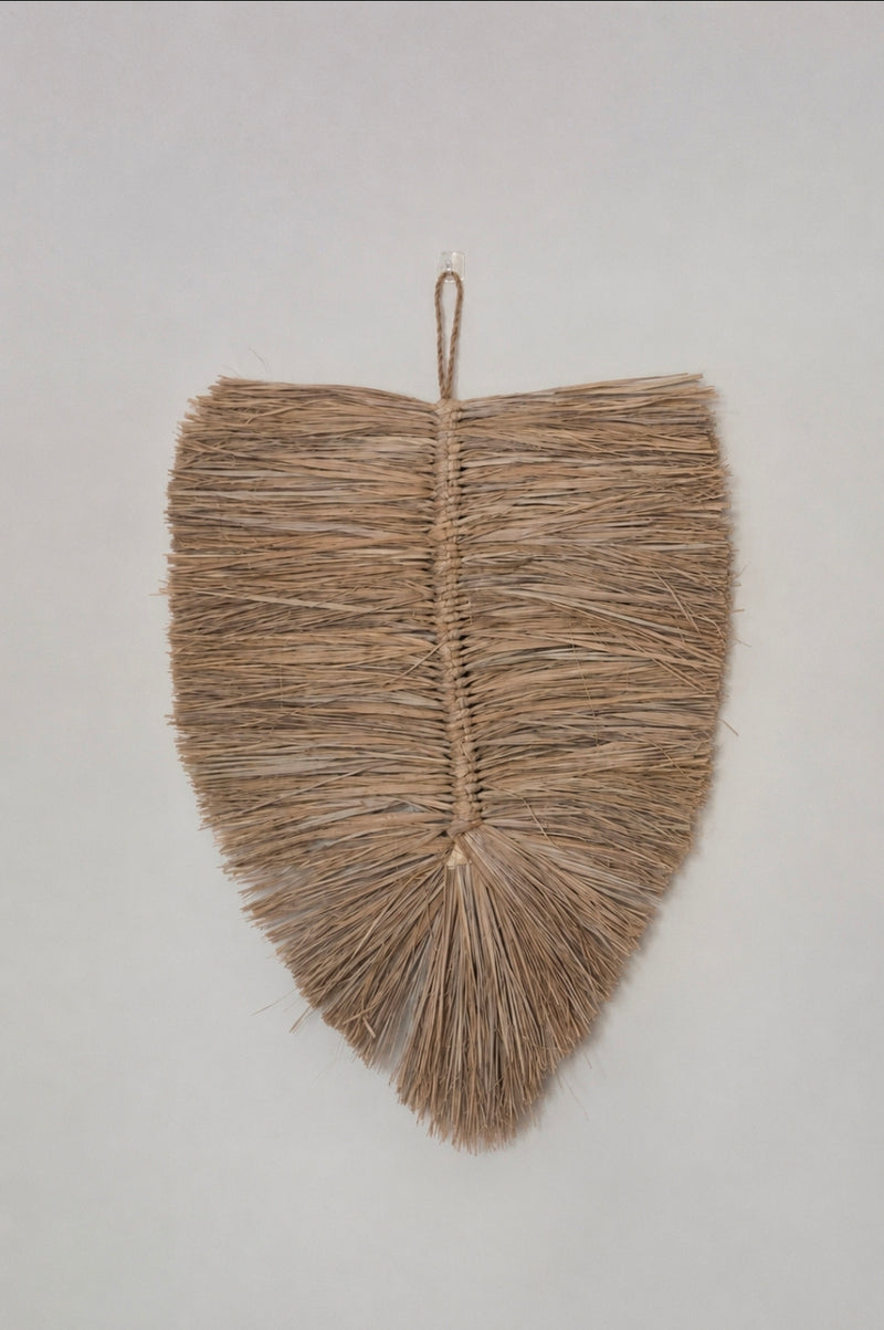 Close-up van raffia wandhanger met natuurlijke structuur 